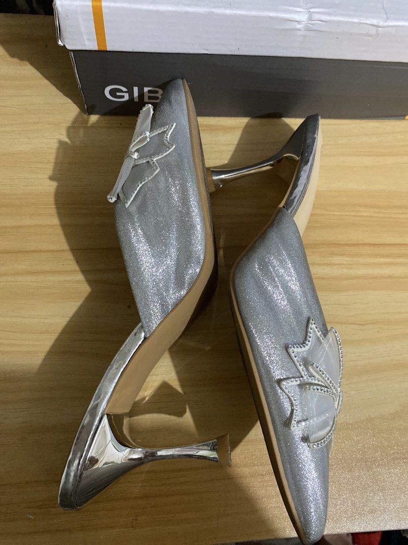 Gibi Silver Glitter Heels with Rhinestone Bow (Category: Heels) located in Makati City. Submitted by oncejjang (Listing ID 1470379890, Image 3). Description: - Brand: Gibi - Style: Pointed-toe high stiletto heels / slip-on mule design - Color/Finish: Silver glitter with sheer mesh bows and rhinestone detailing - Size: 39 - Condition: Great for parties, events, and formal wear.