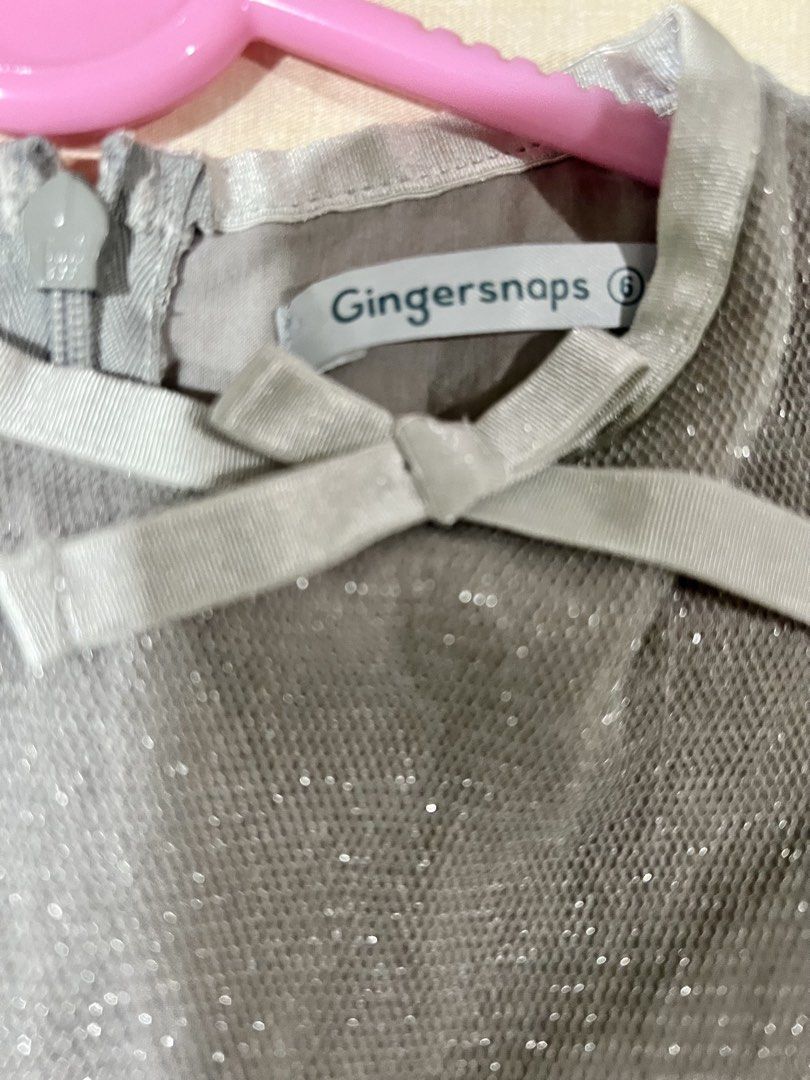 Gingersnaps Grey Tulle Dress (Category: Babies & Kids Fashion) located in Makati City. Submitted by tinkrbelle (Listing ID 1470395323, Image 2). Description: - Brand: Gingersnaps - Size: 6 - Color: Grey with sparkle - Features: Long sheer puff sleeves, back zipper, and a small neck bow - Condition: Excellent, worn a couple of times with no stains or tears *payment thru gcash *delivery fee c/o buyer Thank you.
