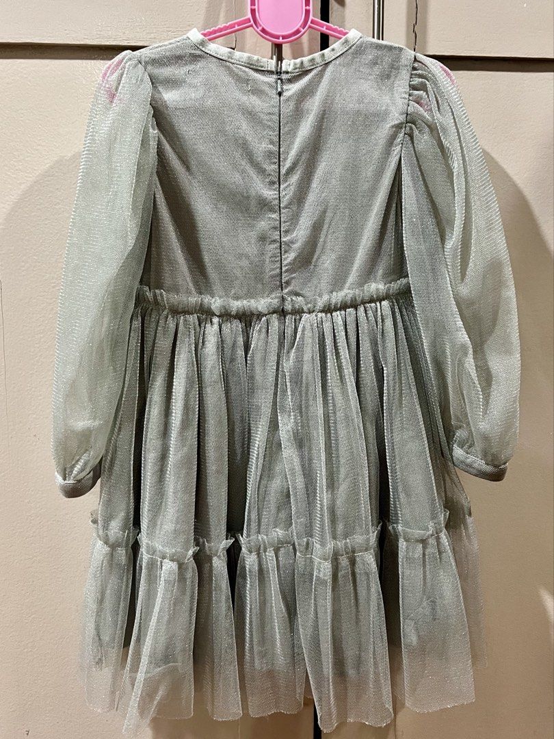 Gingersnaps Grey Tulle Dress (Category: Babies & Kids Fashion) located in Makati City. Submitted by tinkrbelle (Listing ID 1470395323, Image 3). Description: - Brand: Gingersnaps - Size: 6 - Color: Grey with sparkle - Features: Long sheer puff sleeves, back zipper, and a small neck bow - Condition: Excellent, worn a couple of times with no stains or tears *payment thru gcash *delivery fee c/o buyer Thank you.