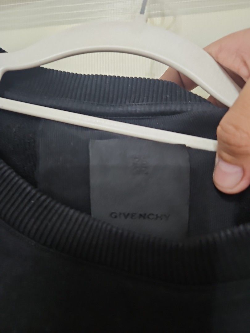 Givenchy Black Graphic Print Sweatshirt Size L (Category: Coats, Jackets and Outerwear) located in Santa Maria. Submitted by rommelmateo (Listing ID 1470531675, Image 3). Description: - Brand: Givenchy - Color: Black - Size: Large (180/100A) - Material: 100% Cotton - Design: Unique stitched patch graphics on upper chest - Details: Ribbed crew neck, cuffs, and hem - Authenticity: Standard interior brand tags and care labels intact.