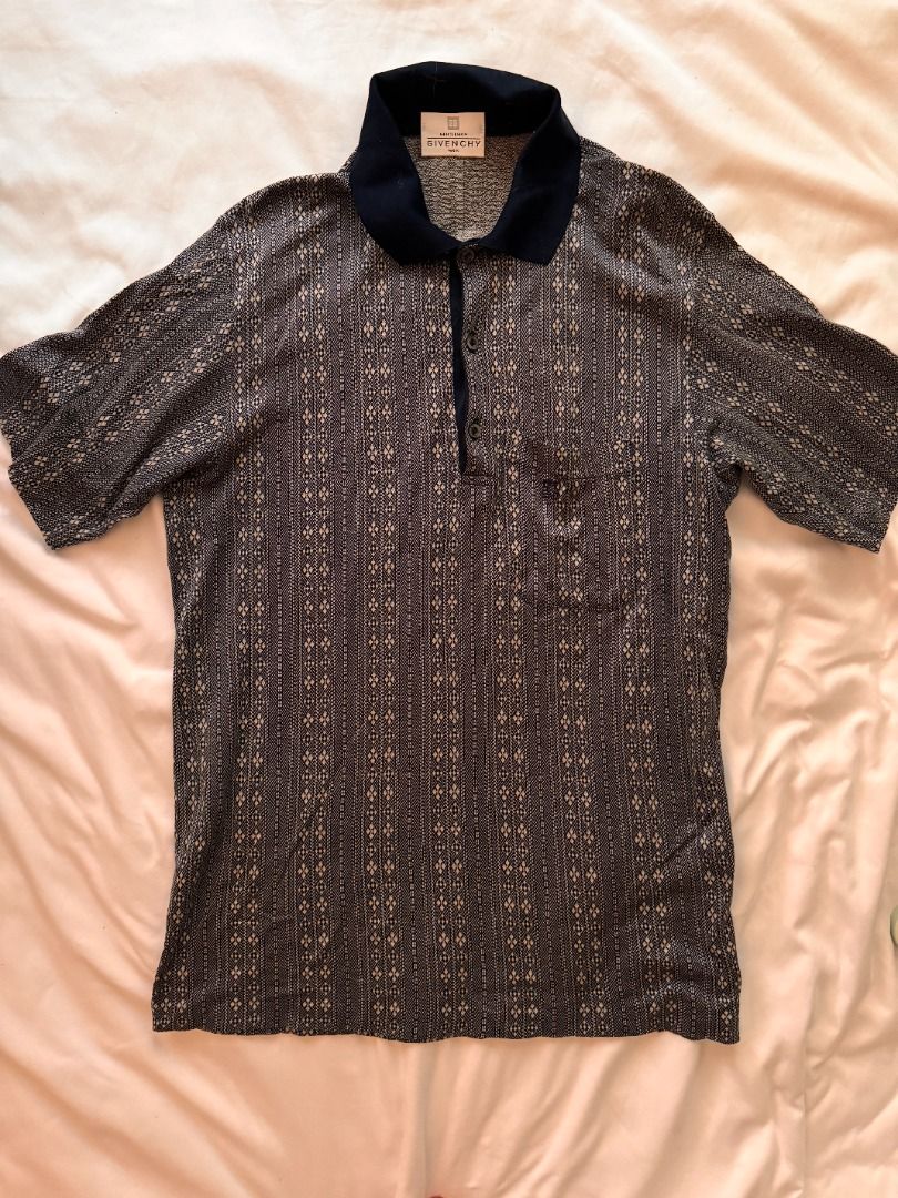Givenchy Patterned Polo Shirt Navy Blue M (Category: Tshirts & Polo Shirts ) located in Cebu City. Submitted by _t.rix (Listing ID 1470374179, Image 1). Description: - Brand: Givenchy - Color: Dark navy blue - Design: Detailed vertical fabric pattern with a solid collar - Features: Three-button placket and left chest pocket - Material: Soft and lightweight - Condition: Great vintage piece, perfect for casual or smart-casual wear.