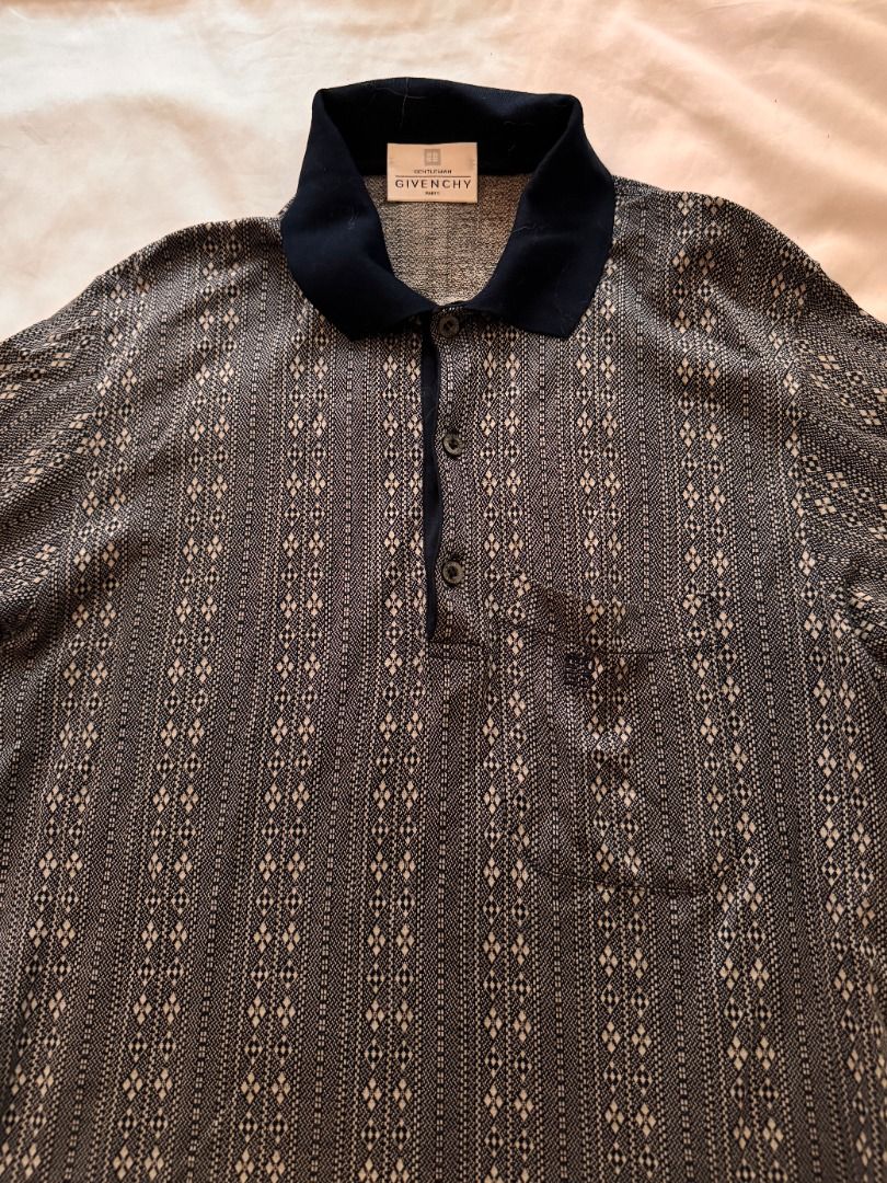 Givenchy Patterned Polo Shirt Navy Blue M (Category: Tshirts & Polo Shirts ) located in Cebu City. Submitted by _t.rix (Listing ID 1470374179, Image 3). Description: - Brand: Givenchy - Color: Dark navy blue - Design: Detailed vertical fabric pattern with a solid collar - Features: Three-button placket and left chest pocket - Material: Soft and lightweight - Condition: Great vintage piece, perfect for casual or smart-casual wear.