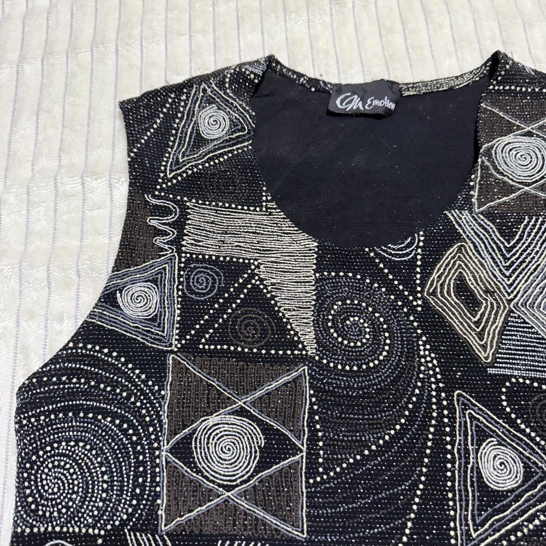 Black Geometric Beadwork-like Sleeveless Tank Top (Category: Sleeveless) located in Manila. Submitted by ish.vintage (Listing ID 1470482463, Image 2). Description: - Color: Black with silver, grey, and bronze beadwork - Stretchy, can fit M-L - Design: Textured geometric beadwork-like swirl patterns with a scoop neckline - Style: Sleeveless tank top, perfect statement piece for parties and evening wear - Detail: Handcrafted look.