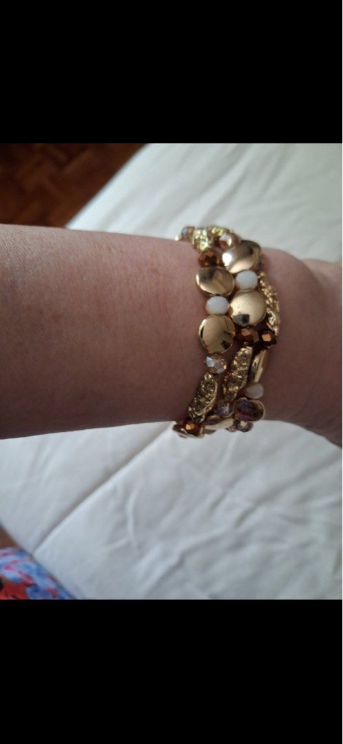 Gold multi-strand bead bracelet (Category: Bracelets) located in Muntinlupa City. Submitted by everythingmustgo_8475da (Listing ID 1470484126, Image 1). Description: - Design: Multi-strand bracelet with gold coins and white beads - Fit: Stretchy cord fits most wrist sizes easily - Appearance: Catches the light nicely for a beautiful sparkle and stacked look - Styling: Perfect for pairing with casual everyday outfits or lovely dresses - Condition: