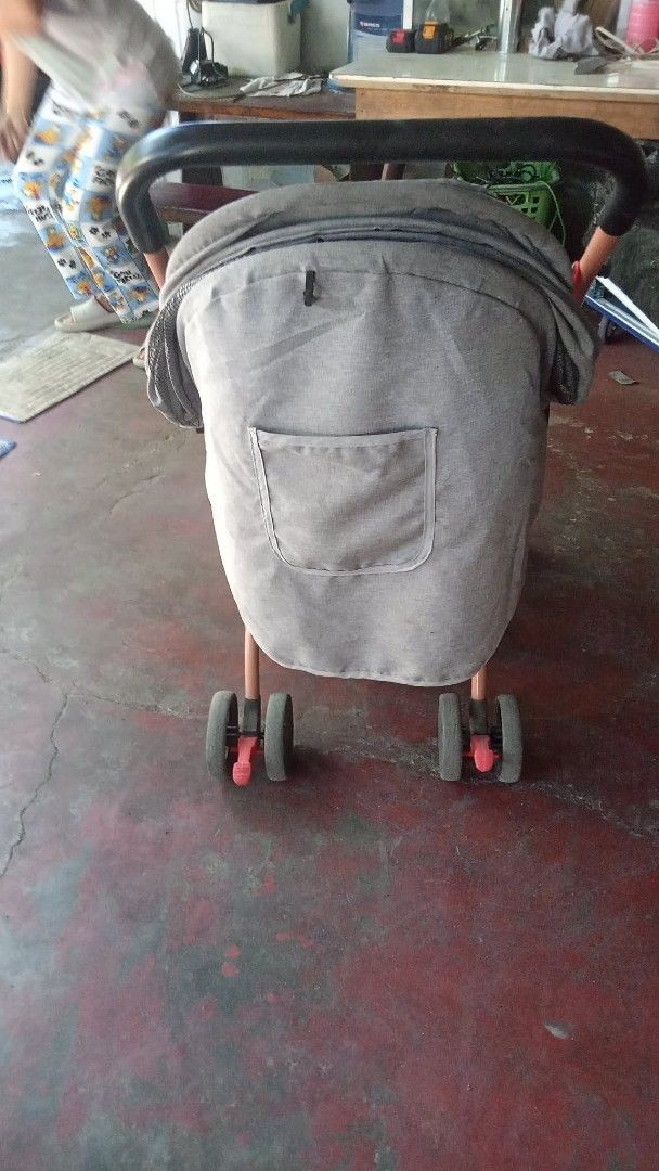 Gray baby stroller with black seat and canopy (Category: Strollers) located in Manila. Submitted by wisegem-231b (Listing ID 1470420022, Image 1). Description: - Gray canopy with a handy back pocket for essentials - Black seat pad equipped with secure safety harness straps - Front footrest tray ideal for snacks and toys - Sturdy frame with a smooth wheeled base - Easy to fold and compact for hassle-free storage - Perfect for daily neighborhood wa