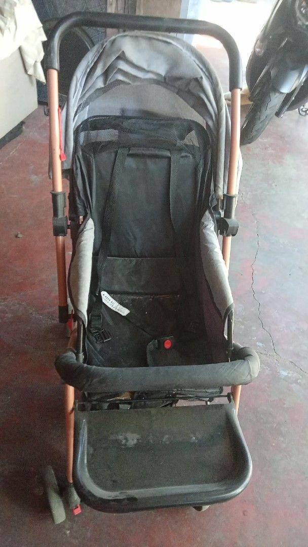 Gray baby stroller with black seat and canopy (Category: Strollers) located in Manila. Submitted by wisegem-231b (Listing ID 1470420022, Image 2). Description: - Gray canopy with a handy back pocket for essentials - Black seat pad equipped with secure safety harness straps - Front footrest tray ideal for snacks and toys - Sturdy frame with a smooth wheeled base - Easy to fold and compact for hassle-free storage - Perfect for daily neighborhood wa