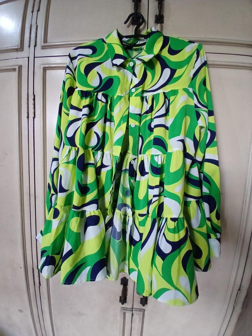 Green Abstract Swirl Pattern Tiered Mini Dress (Category: Dresses) located in Manila. Submitted by f.s_prelov3d (Listing ID 1470476645, Image 2). Description: - Vibrant green, lime, blue, and white abstract swirl print - Funky retro/vintage vibe, perfect for sunny days and casual outings - Features long sleeves, a collared neckline, and a button-up front - Cute, flowy tiered ruffle skirt design - Made from lightweight, easy-to-wear material.