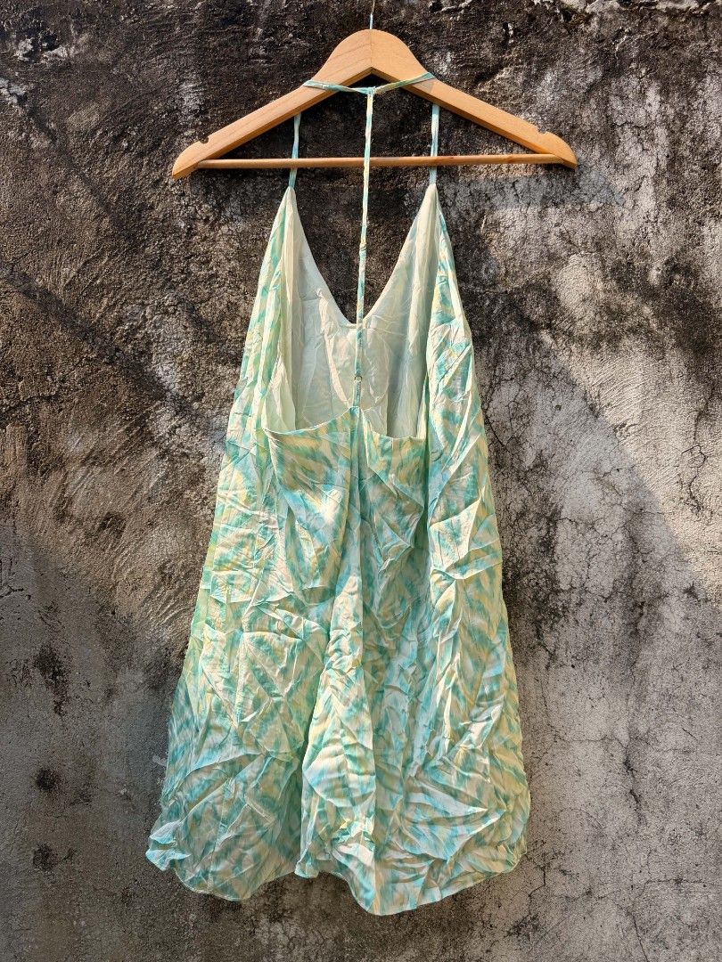 Green and Yellow Patterned Halter Dress (Category: Dresses) located in Batangas. Submitted by vintagesyndicate2 (Listing ID 1470426545, Image 2). Description: - Color/Print: Green and yellow printed - Style: Halter dress with V-neckline and thin back straps - Fit: Relaxed, light, and flowy - Material: Lightweight fabric, easy slip-on wear - Best For: Beach trips, vacations, and warm weather.