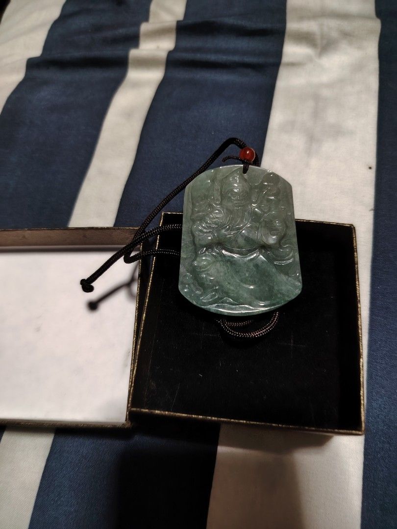 Green Jade Guan Yu Pendant with Box (Category: Jewelry) located in Manila. Submitted by snooks1938 (Listing ID 1470517025, Image 2). Description: FOR SALE.. GUAN YU PENDANT JADE 100% AUTHENTIC PLS MAKE A OFFER.. - Material: Genuine green jade with detailed Guan Yu carving on the front and a smooth back finish - Cord: Adjustable dark brown braided cord accented with a traditional red bead - Presentation: Comes securely packed in an elegant black v