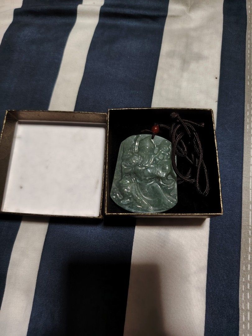 Green Jade Guan Yu Pendant with Box (Category: Jewelry) located in Manila. Submitted by snooks1938 (Listing ID 1470517025, Image 3). Description: FOR SALE.. GUAN YU PENDANT JADE 100% AUTHENTIC PLS MAKE A OFFER.. - Material: Genuine green jade with detailed Guan Yu carving on the front and a smooth back finish - Cord: Adjustable dark brown braided cord accented with a traditional red bead - Presentation: Comes securely packed in an elegant black v