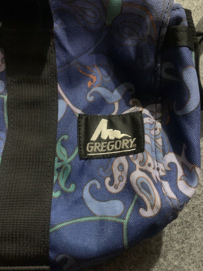 Gregory Blue Paisley Duffel Shoulder Bag (Category: Shoulder Bags) located in Cebu City. Submitted by ninyothrift (Listing ID 1470512015, Image 3). Description: - Brand: Gregory - Design: Stylish blue duffel with all-over paisley pattern - Hardware: Smooth YKK zippers with premium leather pull tabs - Straps: Black carrying handles with snap buttons + adjustable, removable shoulder strap - Details: Classic Gregory woven logo patch on the front - U