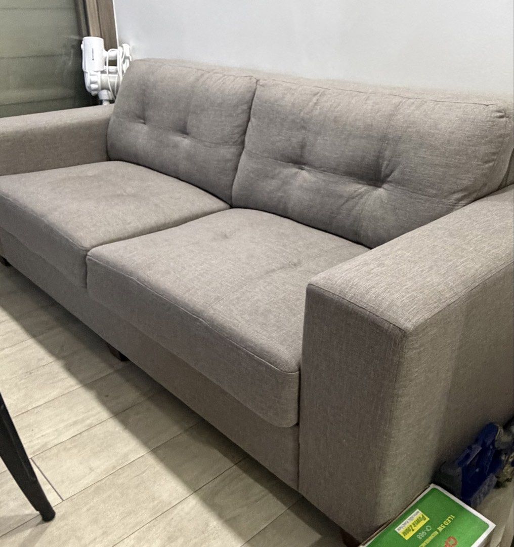 Grey 3-Seater Fabric Sofa (Category: Sofas) located in Manila. Submitted by emchi19 (Listing ID 1470463153, Image 2). Description: - Length: 86 cm. Width: 210 cm. - Color: grey - Type: 3 seater grey fabric sofa - Design: Grey colour with chic tufted button details and wide armrests - arrange for your own pick up at SM WIND TOWER 3 Tagaytay (ex. Lalamove or your own transportation).
