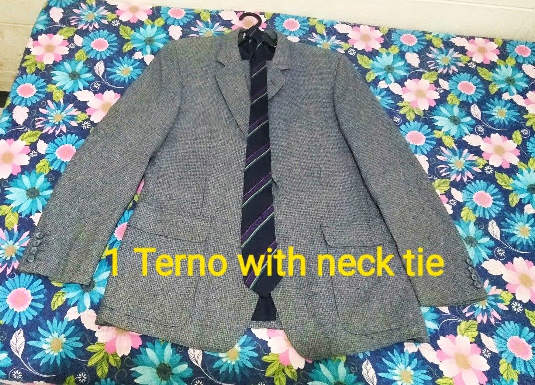Grey terno coat with Matching Neck Tie (Category: Coats, Jackets and Outerwear) located in Cavite. Submitted by keenpenguin.0f27cd (Listing ID 1470451239, Image 1). Description: - Item: Grey patterned suit jacket with matching dark navy blue tie (purple and white diagonal stripes) - Design: Classic notched lapel, front pockets, and four buttons on each cuff - Quality: Clean texture and solid stitching throughout - Ideal For: Formal events, weddin