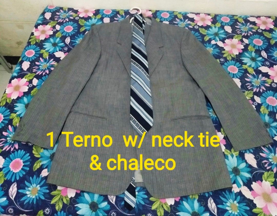 Grey terno coat with Matching Neck Tie (Category: Coats, Jackets and Outerwear) located in Cavite. Submitted by keenpenguin.0f27cd (Listing ID 1470451239, Image 2). Description: - Item: Grey patterned suit jacket with matching dark navy blue tie (purple and white diagonal stripes) - Design: Classic notched lapel, front pockets, and four buttons on each cuff - Quality: Clean texture and solid stitching throughout - Ideal For: Formal events, weddin