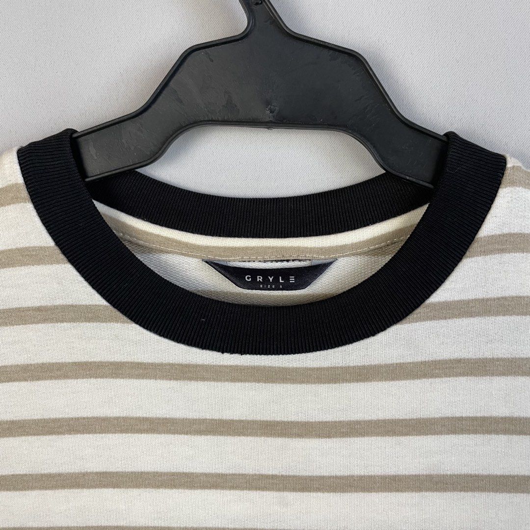 Gryle Apparel | Oversized Micro-Striped Ringer T-Shirt (Category: Tshirts & Polo Shirts ) located in Norzagaray. Submitted by sevenjscloset (Listing ID 1470517599, Image 2). Description: - Brand: Gryle Apparel - Style: Oversized micro-striped ringer t-shirt with contrasting black ribbed collar - Color: Beige and white stripes - Size: Tagged size 3 (Fits Large to XL) - Measurements: 27.5 inches (Length) x 20.5 inches (Width) - Model Reference: 5'1