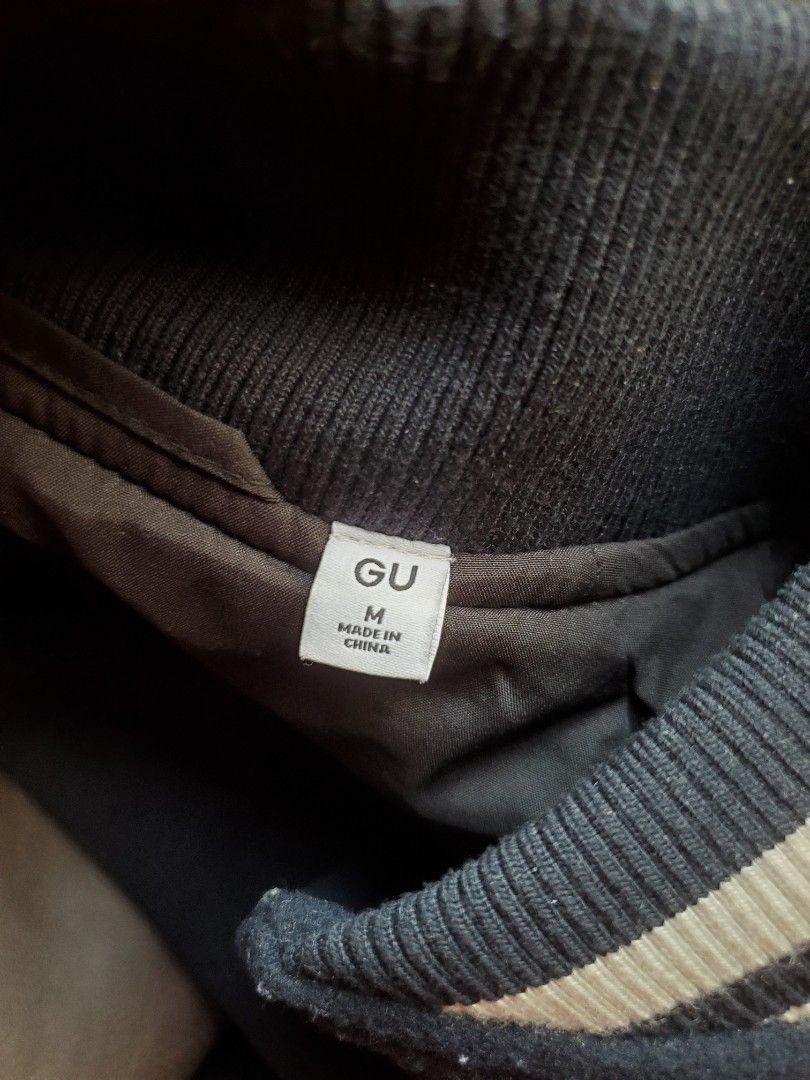 GU Cozy Melton Stadium Jumper (Brown) (Category: Coats, Jackets and Outerwear) located in Manila. Submitted by seanceman (Listing ID 1470381803, Image 2). Description: - Classic college-style varsity jacket - Navy blue wool body with contrast brown faux leather sleeves - Dark blue and white striped ribbed collar, cuffs, and hem - Convenient snap button front closure - Two front welt pockets with trim - Stylish and cozy outerwear for chilly days.