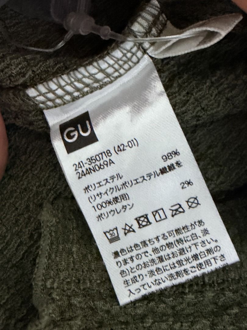 GU Olive Green Textured Short Sleeve Button Top (Category: Blouses) located in Makati City. Submitted by yuriandcole (Listing ID 1470378296, Image 2). Description: - Brand: GU (Style No. 241-350718) - Color: Olive Green - Material: 98% Polyester (with recycled poly), 2% Polyurethane (textured fabric) - Design: Short sleeves, button-front closure, V-neckline, and trendy lettuce hem edges - Care: Machine washable - Condition: Excellent/New - Perfec