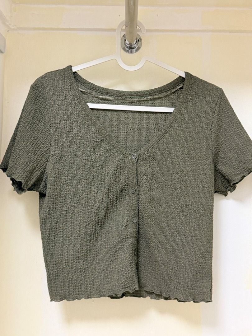 GU Olive Green Textured Short Sleeve Button Top (Category: Blouses) located in Makati City. Submitted by yuriandcole (Listing ID 1470378296, Image 1). Description: - Brand: GU (Style No. 241-350718) - Color: Olive Green - Material: 98% Polyester (with recycled poly), 2% Polyurethane (textured fabric) - Design: Short sleeves, button-front closure, V-neckline, and trendy lettuce hem edges - Care: Machine washable - Condition: Excellent/New - Perfec