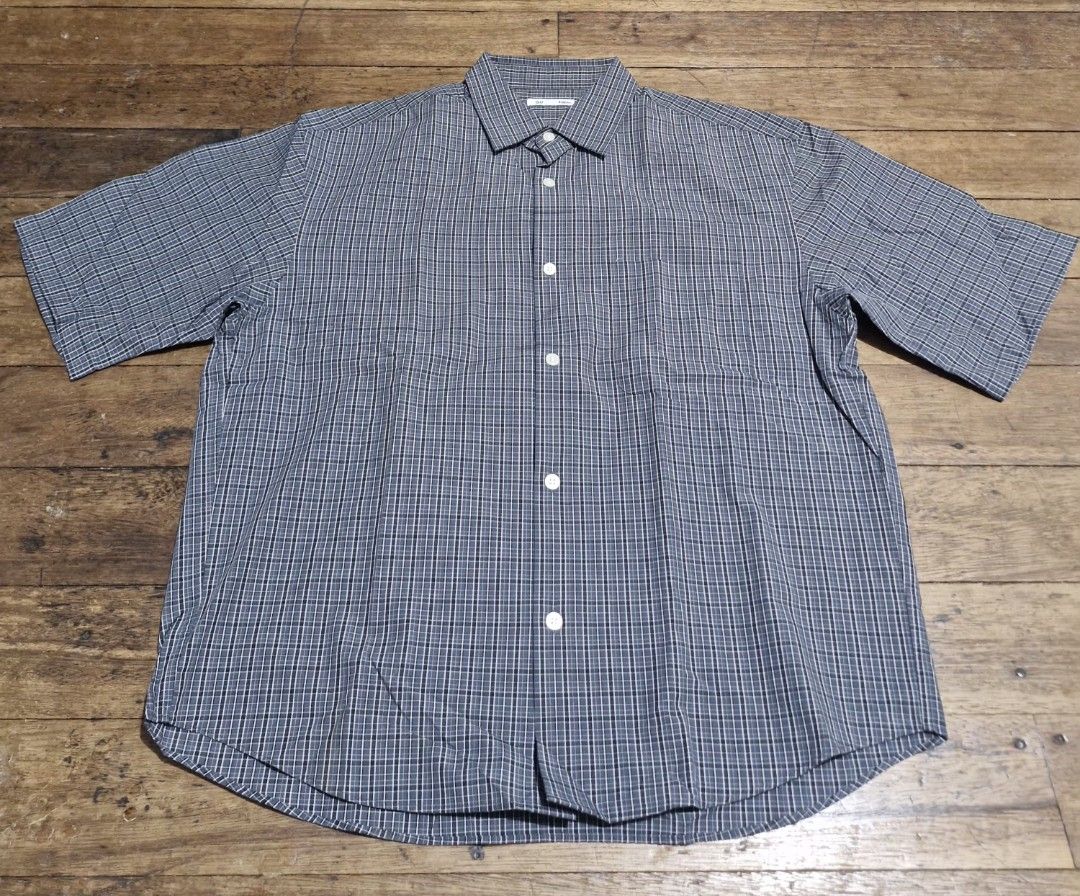 GU Short Sleeve Plaid Button-Down Shirt (Category: Tshirts & Polo Shirts ) located in Manila. Submitted by blackstarharpoon (Listing ID 1470523215, Image 1). Description: - Brand: GU - Style: Short-sleeve button-down shirt - Pattern: Dark grey and white plaid - Details: Classic collar, white front buttons, left chest pocket - Fabric: Lightweight and breathable, perfect for the PH weather - Condition: Excellent, ready to wear.