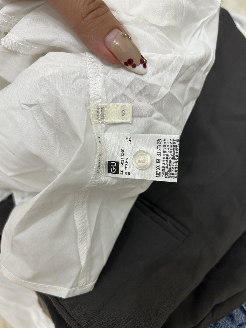 GU White Ruffle Puff Sleeve Button-Up Blouse Size S (Category: Blouses) located in Valencia. Submitted by crizzagella20 (Listing ID 1470545796, Image 2). Description: - Brand: GU - Size: Small - Color: White - Material: Cotton and polyester blend - Design: V-neck with front buttons - Details: Short puff sleeves with ruffle trim along shoulders and neckline - Condition: Clean and ready to wear.