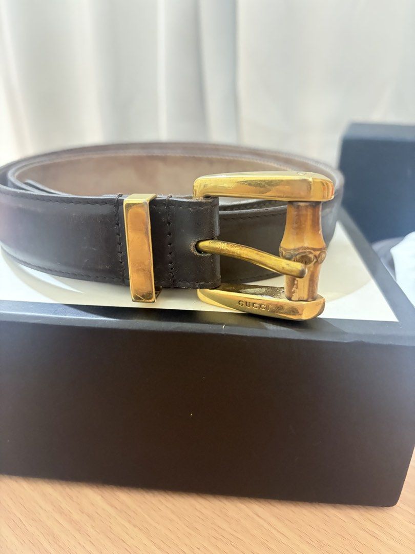 Gucci Bamboo Buckle Leather Belt (Category: Belts) located in Iloilo. Submitted by miafinds (Listing ID 1470386672, Image 1). Description: - Brand: Authentic Gucci - Color: Dark brown leather with tan interior lining - Hardware: Distinctive gold-tone bamboo-style metal buckle with engraved Gucci branding - Condition: Excellent, stored in original presentation box - Style: Versatile designer accessory perfect for everyday wear.
