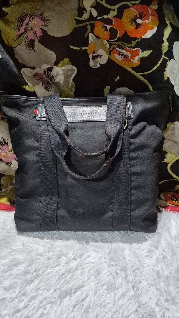 Gucci Black Canvas Tote Bag (Category: Tote Bags) located in Baguio. Submitted by jhaz_bags (Listing ID 1470503563, Image 1). Description: - Authentic Gucci black canvas tote bag - Features signature dual web handles and interior fabric lining - Leather tag stamped with "Gucci Made in Italy" - Canvas body has minor, normal use marks - Note: Handles show heavy wear and fraying at the grip area - A classic, spacious everyday carryall.