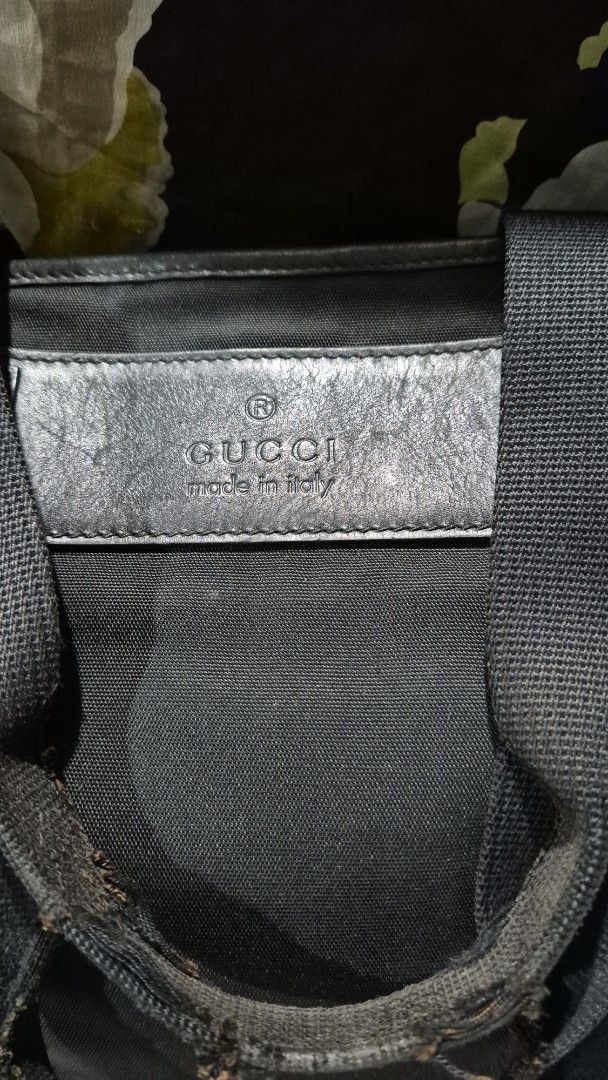 Gucci Black Canvas Tote Bag (Category: Tote Bags) located in Baguio. Submitted by jhaz_bags (Listing ID 1470503563, Image 2). Description: - Authentic Gucci black canvas tote bag - Features signature dual web handles and interior fabric lining - Leather tag stamped with "Gucci Made in Italy" - Canvas body has minor, normal use marks - Note: Handles show heavy wear and fraying at the grip area - A classic, spacious everyday carryall.