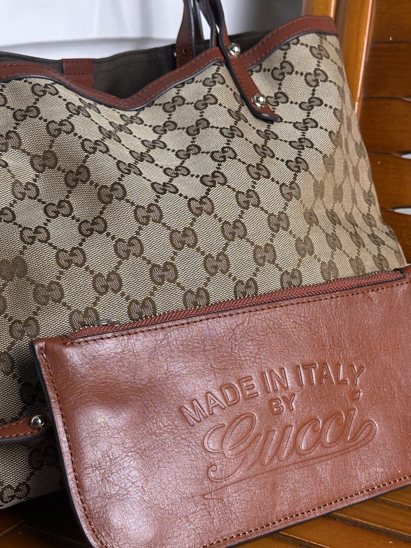 Gucci GG Canvas Tote Bag Brown (Category: Tote Bags) located in Santa Rosa. Submitted by shop818 (Listing ID 1470412130, Image 2). Description: - Gucci GG monogram canvas tote bag (searchable code) - Elegant brown leather trim and silver-tone hardware with brand engravings - Comfortable double shoulder straps for easy wear - Spacious brown fabric-lined interior for all your daily essentials - Includes a matching leather pouch embossed with 'Made 