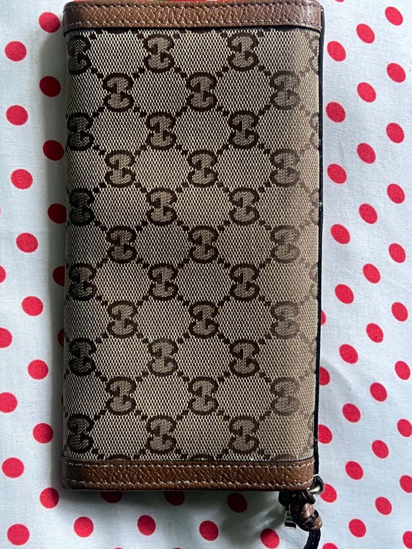 Gucci GG Monogram Long Wallet Brown Leather (Category: Luxury Bags & Wallets) located in Manila. Submitted by nerakcastr16833 (Listing ID 1470448545, Image 2). Description: - Authentic classic Gucci long wallet - Iconic GG monogram canvas with elegant brown leather trim - Secure snap button closure - Multiple card slots and spacious slip compartments - Convenient zippered coin pouch - Clean interior and exterior, ready for daily use.
