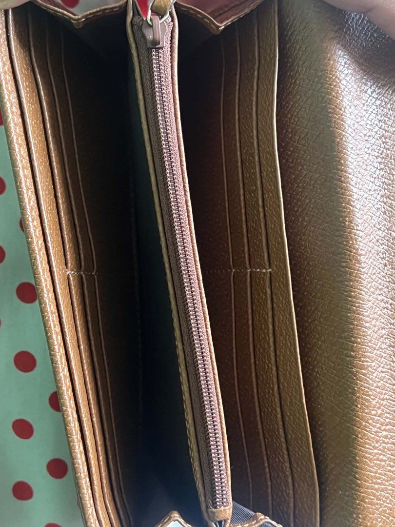 Gucci GG Monogram Long Wallet Brown Leather (Category: Luxury Bags & Wallets) located in Manila. Submitted by nerakcastr16833 (Listing ID 1470448545, Image 3). Description: - Authentic classic Gucci long wallet - Iconic GG monogram canvas with elegant brown leather trim - Secure snap button closure - Multiple card slots and spacious slip compartments - Convenient zippered coin pouch - Clean interior and exterior, ready for daily use.