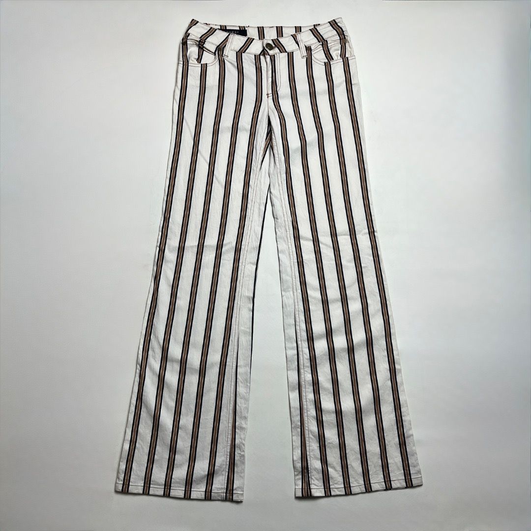 Gucci Tom Ford Striped Pants (Category: Jeans) located in Caloocan City. Submitted by achilles_grails (Listing ID 1470460972, Image 1). Description: - Brand: Gucci (Tom Ford era style) - Design: White pants with classic brown and black vertical stripes - Details: Features iconic Gucci leather back patch and branded interior tags - Origin: Made in Italy - Condition: Excellent pre-owned condition with clean stitching and hardware.
