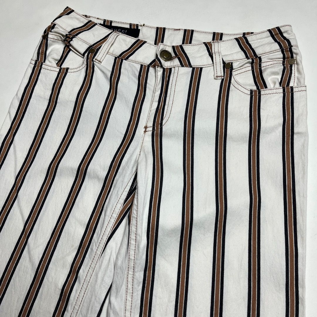 Gucci Tom Ford Striped Pants (Category: Jeans) located in Caloocan City. Submitted by achilles_grails (Listing ID 1470460972, Image 3). Description: - Brand: Gucci (Tom Ford era style) - Design: White pants with classic brown and black vertical stripes - Details: Features iconic Gucci leather back patch and branded interior tags - Origin: Made in Italy - Condition: Excellent pre-owned condition with clean stitching and hardware.