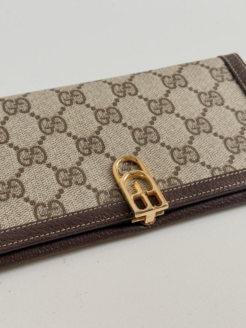 Gucci Vintage Monogram Canvas Long Wallet Brown (Category: Luxury Bags & Wallets) located in Quezon City. Submitted by official_kiyowo.vintage (Listing ID 1470351873, Image 2). Description: - Brand: Vintage Gucci - Material: Brown monogram canvas with dark brown leather trim - Hardware: Gold-tone front clasp closure - Interior: Dark brown leather with gold stamped 'Made in Italy by Gucci' logo - Storage: Multiple compartments for cards and cash -