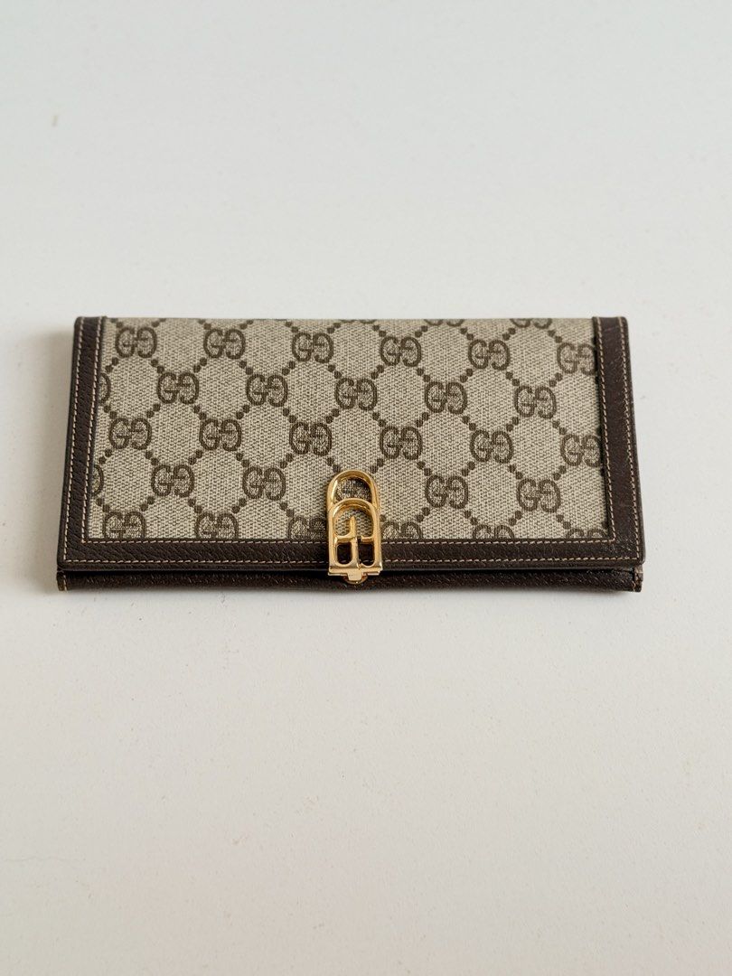 Gucci Vintage Monogram Canvas Long Wallet Brown (Category: Luxury Bags & Wallets) located in Quezon City. Submitted by official_kiyowo.vintage (Listing ID 1470351873, Image 1). Description: - Brand: Vintage Gucci - Material: Brown monogram canvas with dark brown leather trim - Hardware: Gold-tone front clasp closure - Interior: Dark brown leather with gold stamped 'Made in Italy by Gucci' logo - Storage: Multiple compartments for cards and cash -