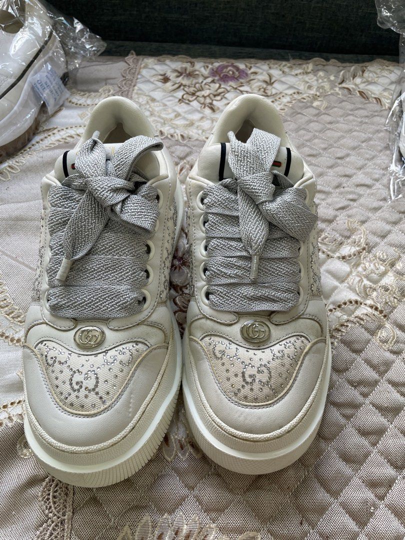 Gucci White Leather Rhinestone Platform Sneakers (Category: Sneakers & Footwear) located in Manila. Submitted by escarchame98247 (Listing ID 1470490285, Image 1). Description: - Brand: Gucci - Color: White - Material: Premium leather - Features: Crystal-embellished toe box, wide silver ribbon laces, gold interlocking G hardware, and green/red web stripe on the tongue - Sole: Textured platform with iconic bee design on the bottom - Condition: Exce