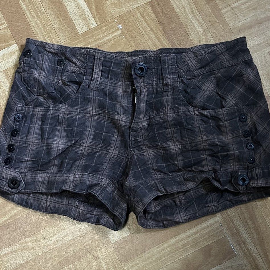 Guess Jeans Brown Plaid Cargo Shorts (Category: Shorts) located in Binan City. Submitted by peachilee (Listing ID 1470431870, Image 1). Description: - Brand: Guess Jeans - Color/Pattern: Brown and dark tones plaid - Fit: Mid-rise - Closure: Button fly with branded metal hardware - Style: Utility with front button details and zipped back pockets - Details: Guess Los Angeles leather patch on the back waistband - Fabric: Textured material with a dar