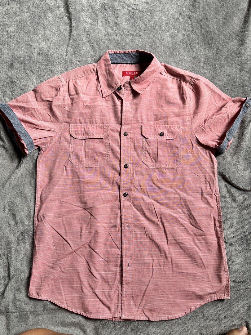 Guess Men Short Sleeve Button Down Shirt Pink Size S (Category: Tshirts & Polo Shirts ) located in Urdaneta. Submitted by m1k3yl (Listing ID 1470370113, Image 1). Description: - Brand: Guess - Style: Short sleeve button-down shirt - Color: Pink with subtle striped pattern - Size: Small (tag attached inside red neck label) - Details: Two chest pockets with button flaps, grey contrast lining on collar, and grey trim on cuffs - Fit/Material: Lightwe