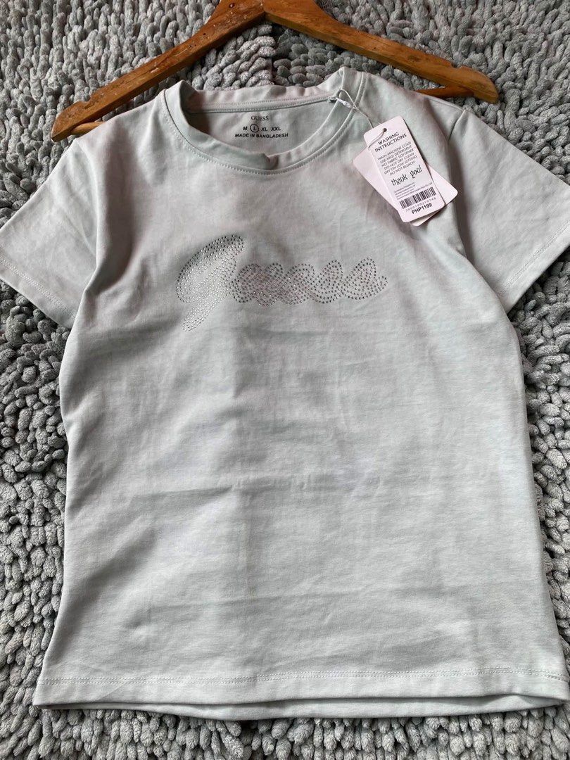 Guess Rhinestone Logo T-Shirt (Category: Shirts) located in Batangas. Submitted by rm0401 (Listing ID 1470437585, Image 1). Description: - Brand: Guess - Style: Short sleeve t-shirt with crew neckline and regular fit - Size: L (tagged on inner collar) - Condition: Brand new with original retail tags attached (PHP price shown) - Origin: Made in Bangladesh fits to: small-large.