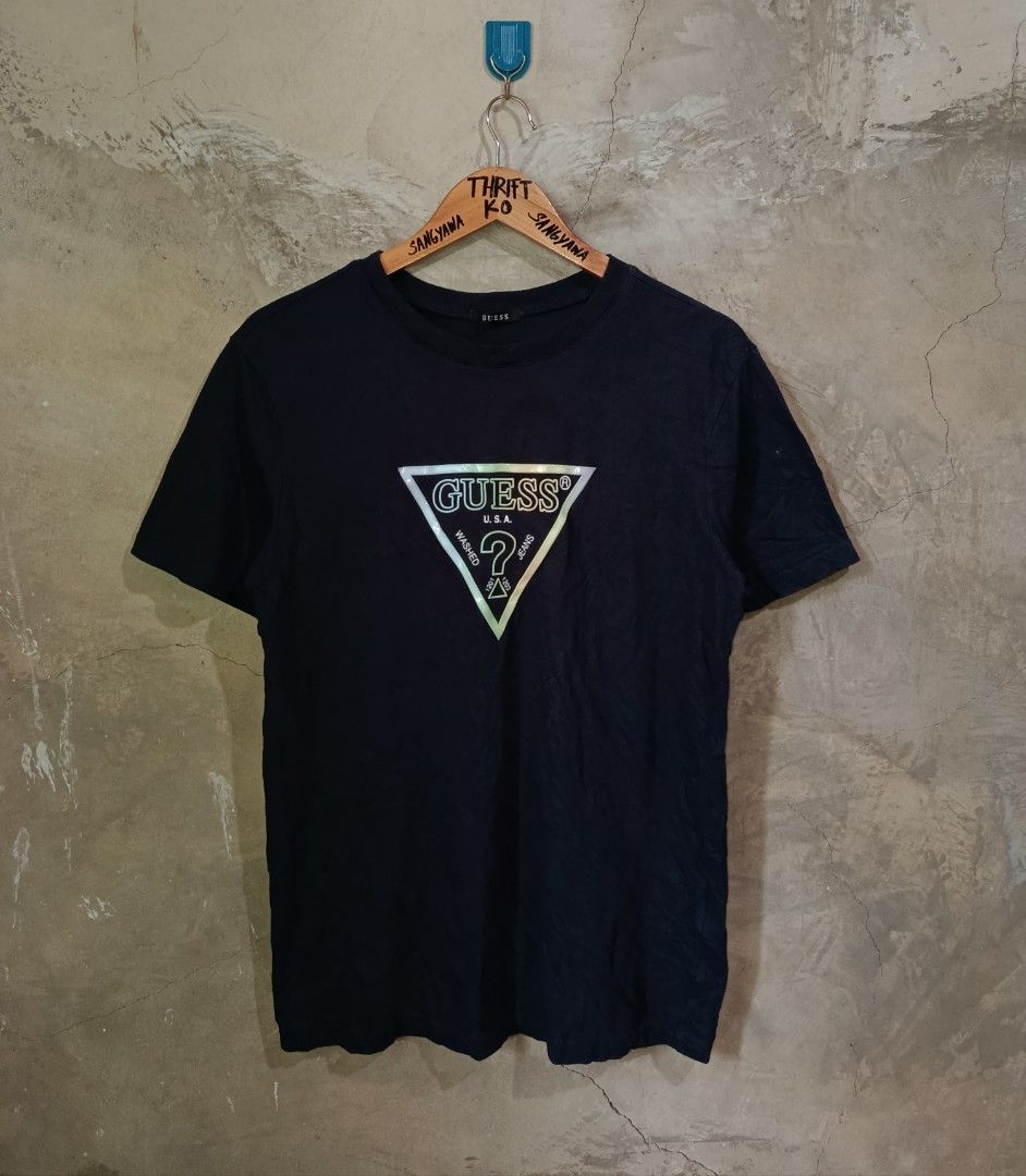Guess Triangle Logo Black T-Shirt Size L (Category: Tshirts & Polo Shirts ) located in Kalamansig. Submitted by skone1996 (Listing ID 1470429094, Image 1). Description: - Brand: Guess - Style Number: NM2K9408 - Size: L - 20 Width - 27 Length - 9.8/10 Color rate - No issue - Material: 100% Cotton - Color: Black - Design: Classic Guess triangle logo with an iridescent finish, crew neck, short sleeves - Condition: Excellent, clean collar tag and int