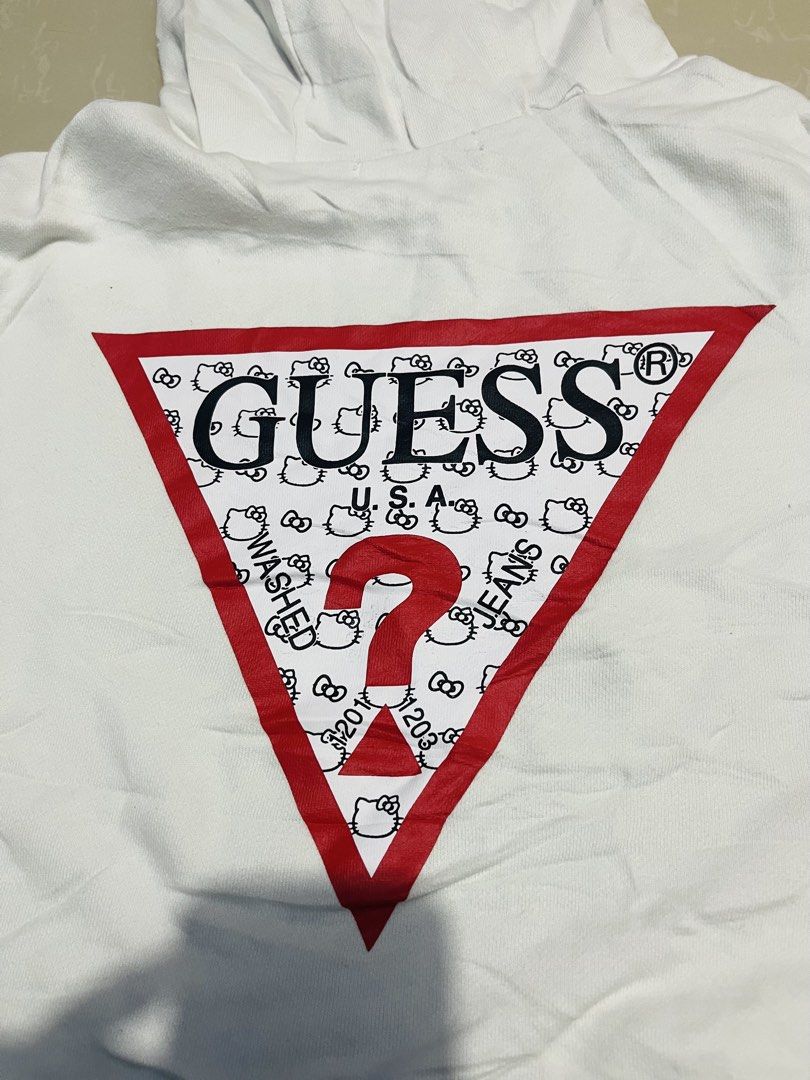 Guess x Hello Kitty White Hoodie Size S (Category: Coats, Jackets and Outerwear) located in Manila. Submitted by athan0800 (Listing ID 1470417845, Image 3). Description: Guess x Kitty white hoodie, size S. Style number MZ4K7775HK. 100% cotton body and hood lining. Red logo lettering across chest, large Guess triangle logo with Kitty graphics on the back. Drawstring hood, front kangaroo pocket. Ribbed cuffs and hem..