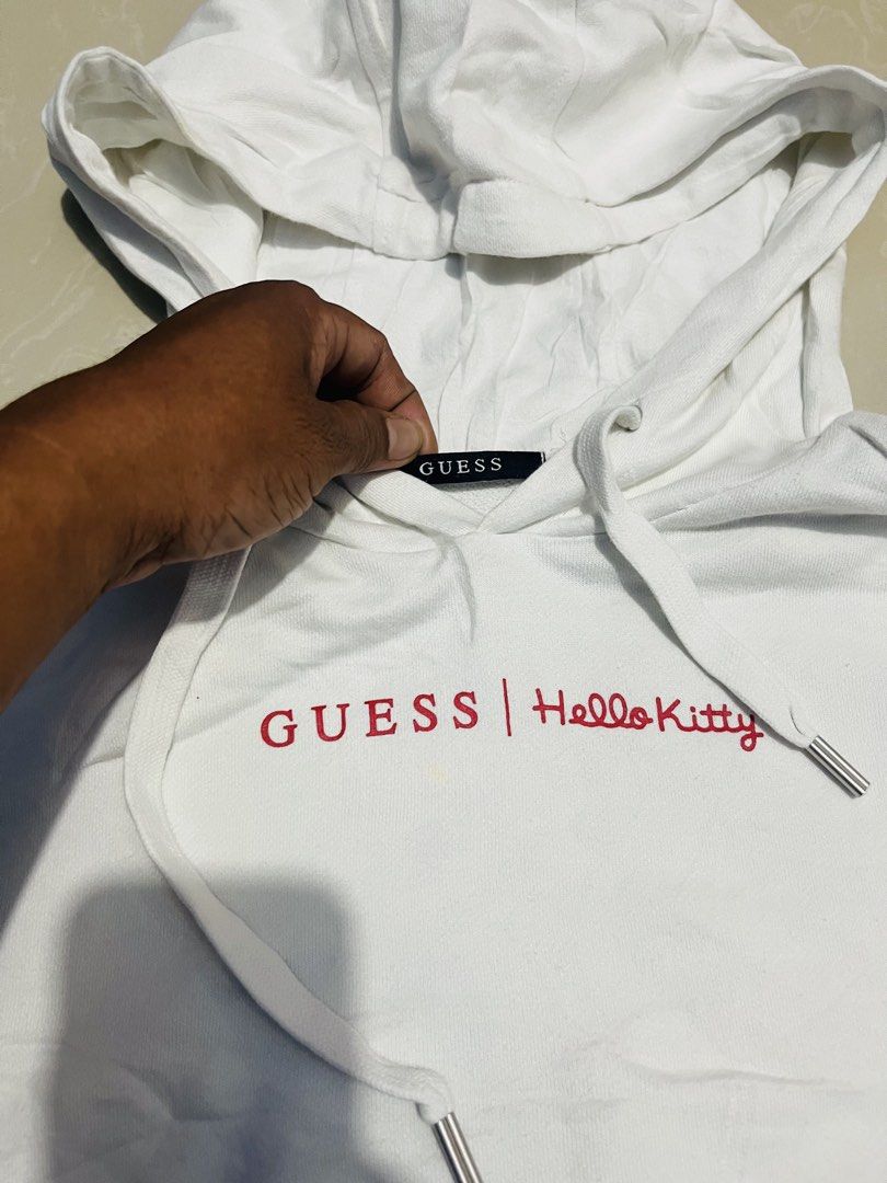 Guess x Hello Kitty White Hoodie Size S (Category: Coats, Jackets and Outerwear) located in Manila. Submitted by athan0800 (Listing ID 1470417845, Image 2). Description: Guess x Kitty white hoodie, size S. Style number MZ4K7775HK. 100% cotton body and hood lining. Red logo lettering across chest, large Guess triangle logo with Kitty graphics on the back. Drawstring hood, front kangaroo pocket. Ribbed cuffs and hem..