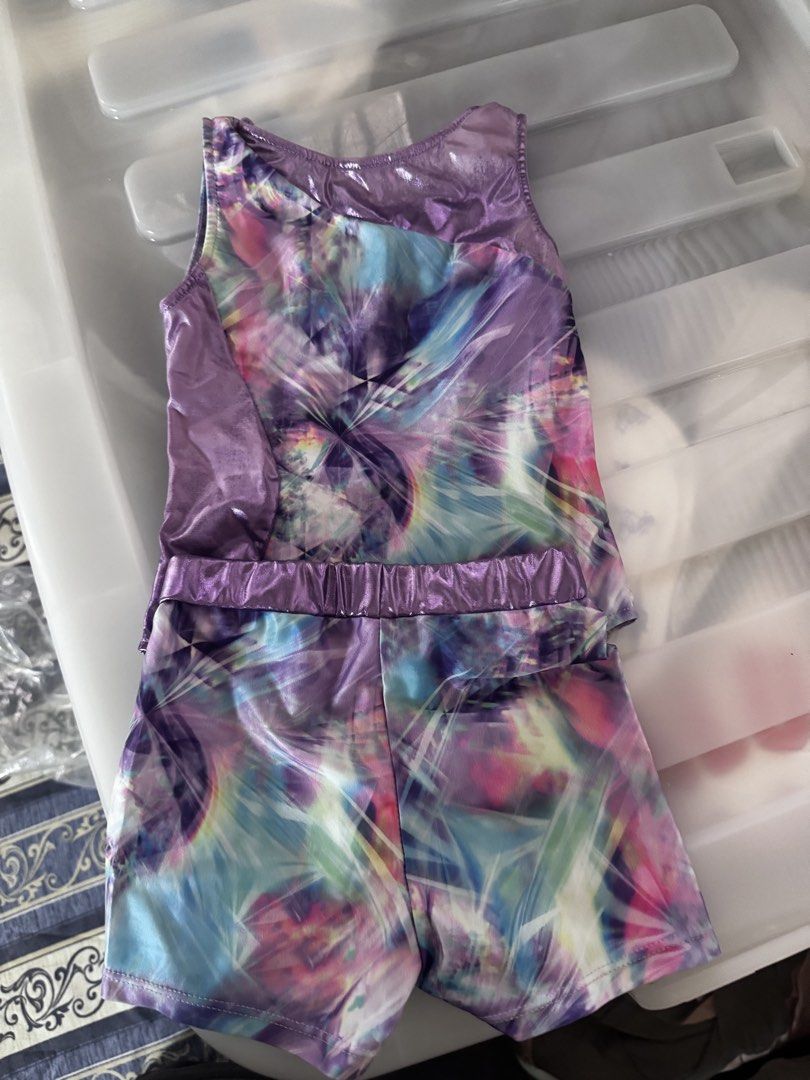 Gymnastics Leotard and Shorts Set Multiple Colors (Category: Babies & Kids Fashion) located in Davao. Submitted by kb_bautista (Listing ID 1470357501, Image 3). Description: - Set of 3 sleeveless gymnastics leotard sets (tops and matching shorts) - Design 1: Black with colorful stars and metallic silver trim - Design 2: Rainbow starburst pattern with pink metallic trim - Design 3: Purple and blue abstract crystal pattern with metallic purple trim