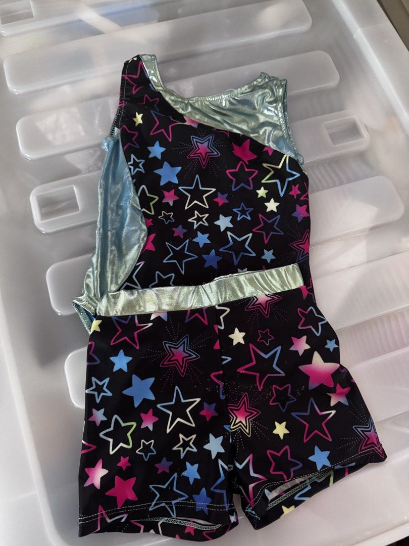 Gymnastics Leotard and Shorts Set Multiple Colors (Category: Babies & Kids Fashion) located in Davao. Submitted by kb_bautista (Listing ID 1470357501, Image 1). Description: - Set of 3 sleeveless gymnastics leotard sets (tops and matching shorts) - Design 1: Black with colorful stars and metallic silver trim - Design 2: Rainbow starburst pattern with pink metallic trim - Design 3: Purple and blue abstract crystal pattern with metallic purple trim