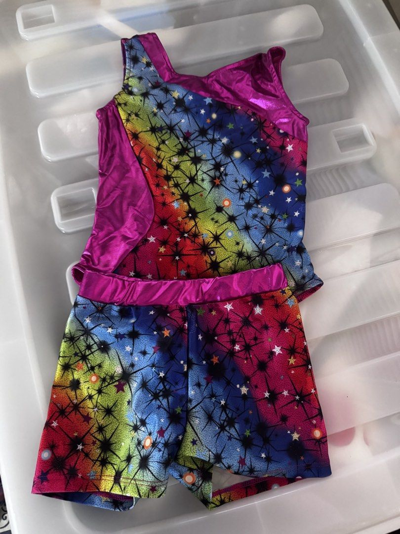 Gymnastics Leotard and Shorts Set Multiple Colors (Category: Babies & Kids Fashion) located in Davao. Submitted by kb_bautista (Listing ID 1470357501, Image 2). Description: - Set of 3 sleeveless gymnastics leotard sets (tops and matching shorts) - Design 1: Black with colorful stars and metallic silver trim - Design 2: Rainbow starburst pattern with pink metallic trim - Design 3: Purple and blue abstract crystal pattern with metallic purple trim