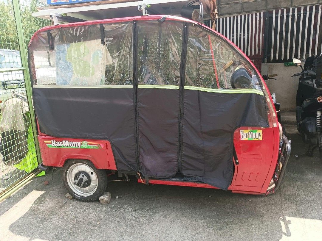 HARMONY E BIKE (Category: Motorbikes for Sale) located in Manila. Submitted by dj_deung (Listing ID 1470495472, Image 2). Description: HARMONY BRAND - Color: Striking red with blue upholstered seating - Power: De charge and also Eco-friendly roof-mounted solar panel setup kaya malakas ang hatak. - Enclosure: Black side curtains featuring clear plastic windows pwede for 3 adult passengers or pwede panghakot. - Protection & Lighting: Front bullbar 
