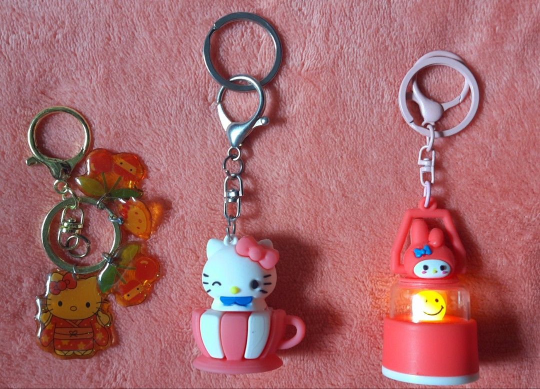 Hello Kitty and My Melody Keychain Bundle (Category: Character Goods) located in Manila. Submitted by declutter.mnla (Listing ID 1470375266, Image 2). Description: - Set of 3 Hello Kitty, My Melody keychains - Kitty acrylic charm with cute cherry accents - Kitty teacup collectible figure - My Melody glowing lantern toy - Finished with stylish gold and pink hardware - Perfect fun lot for Hello Kitty/ My Melody collectors - Excellent as charms on w