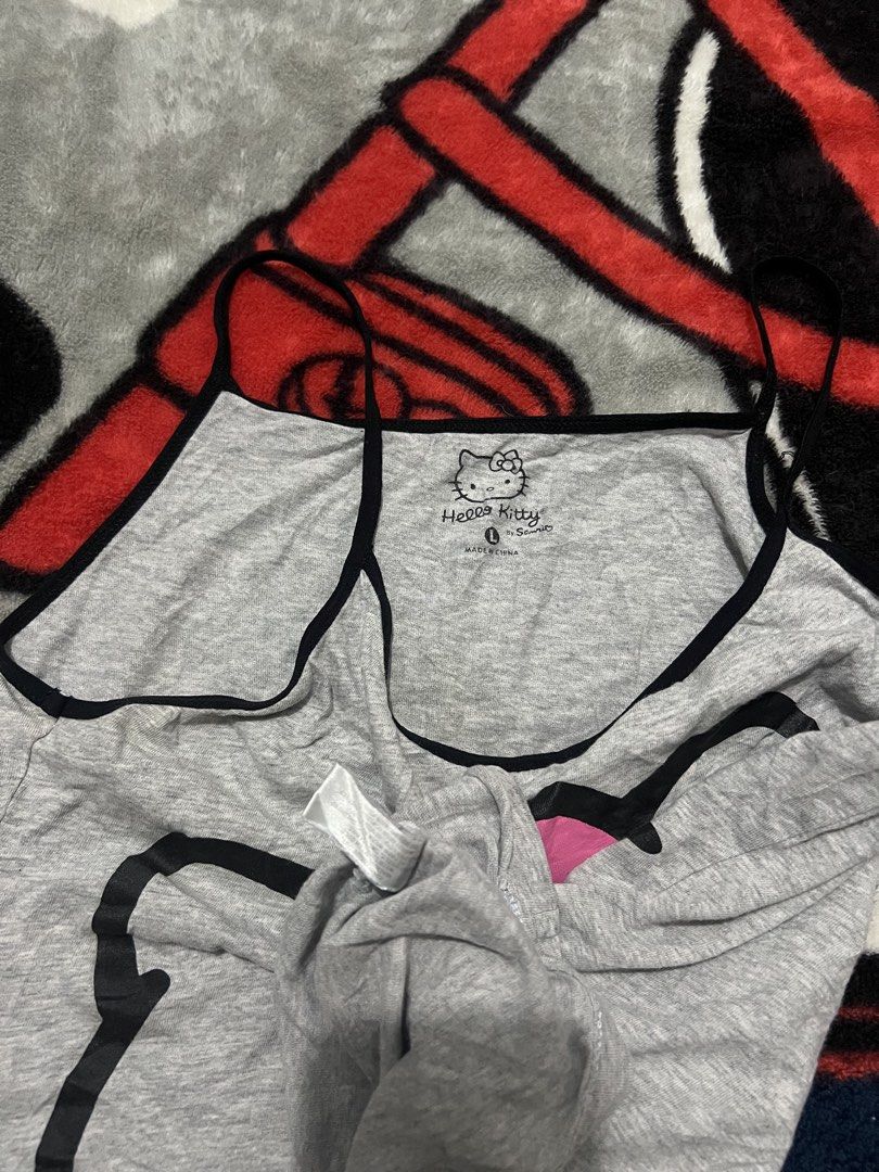 Hello Kitty Grey Cami Tank Top Size L Sanrio (Category: Sleeveless) located in Tanza. Submitted by 1954_street (Listing ID 1470380717, Image 2). Description: HELLO KITTY WOMENS TOP large 15x19 excellent 300 - Brand: Sanrio - Size: L - Color: Grey with black trim and straps - Design: Large Kitty graphic with pink bow - Material: Soft cotton - Condition: Excellent / Casual everyday wear - Made in: China.