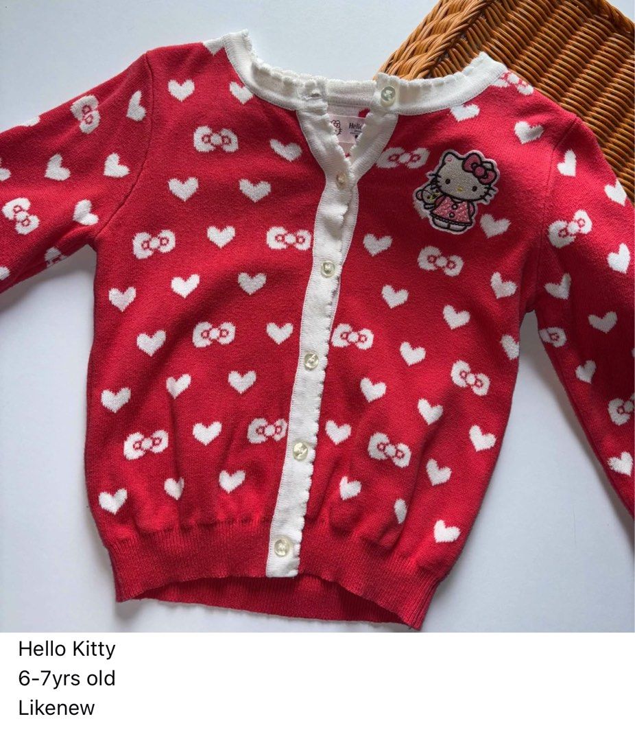 Hello Kitty Red Cardigan 6-7 Years Old (Category: Babies & Kids Fashion) located in Manila. Submitted by miamoire (Listing ID 1470556546, Image 1). Description: - Adorable red knitted cardigan with white hearts and Kitty bow patterns - Features a cute embroidered Kitty patch on the chest - White button-up front closure with a comfortable ribbed hem - Size: Fits girls aged 6 to 7 years old - Condition: Brand new / Excellent quality - Perfect for c