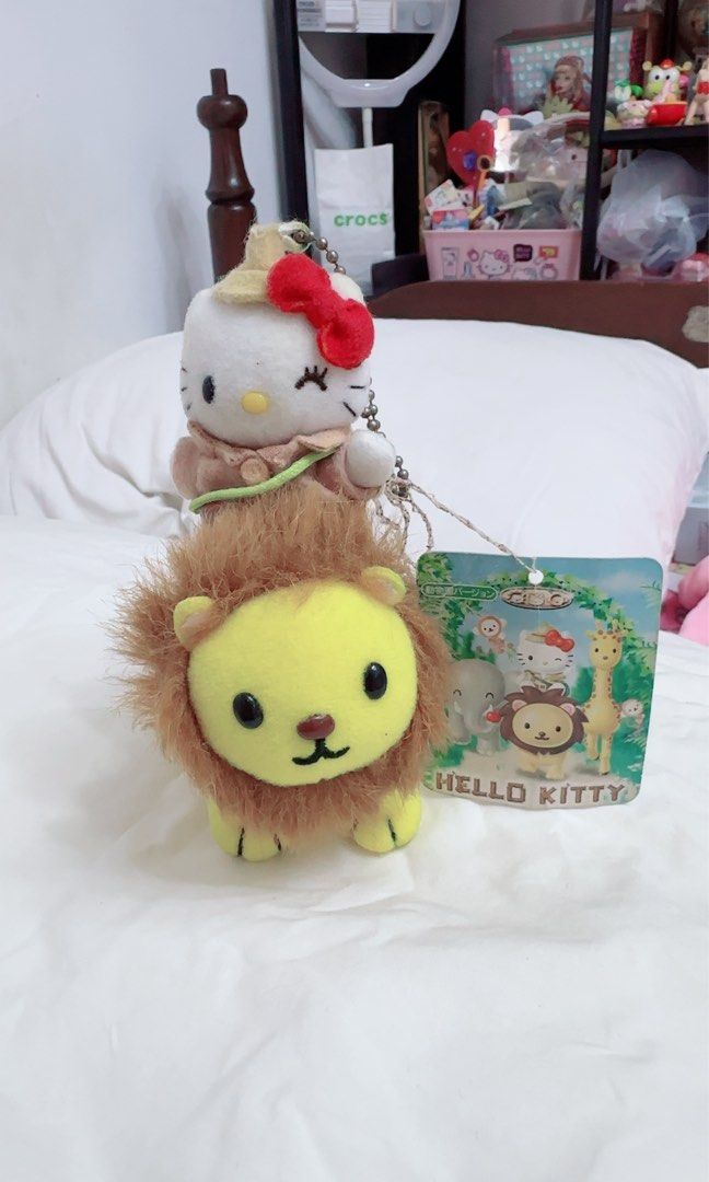 Hello Kitty Safari Lion Plush charm Keychain (Category: Plushies & Soft Toys) located in Quezon City. Submitted by lhewcifer (Listing ID 1470358288, Image 1). Description: - Rare Sanrio collectible featuring Kitty riding a yellow lion in an explorer outfit - Made with super soft, huggable fabric on both characters - Includes the original paper tag showing other animals from the safari collection - Equipped with a hanging chain at the top for easy