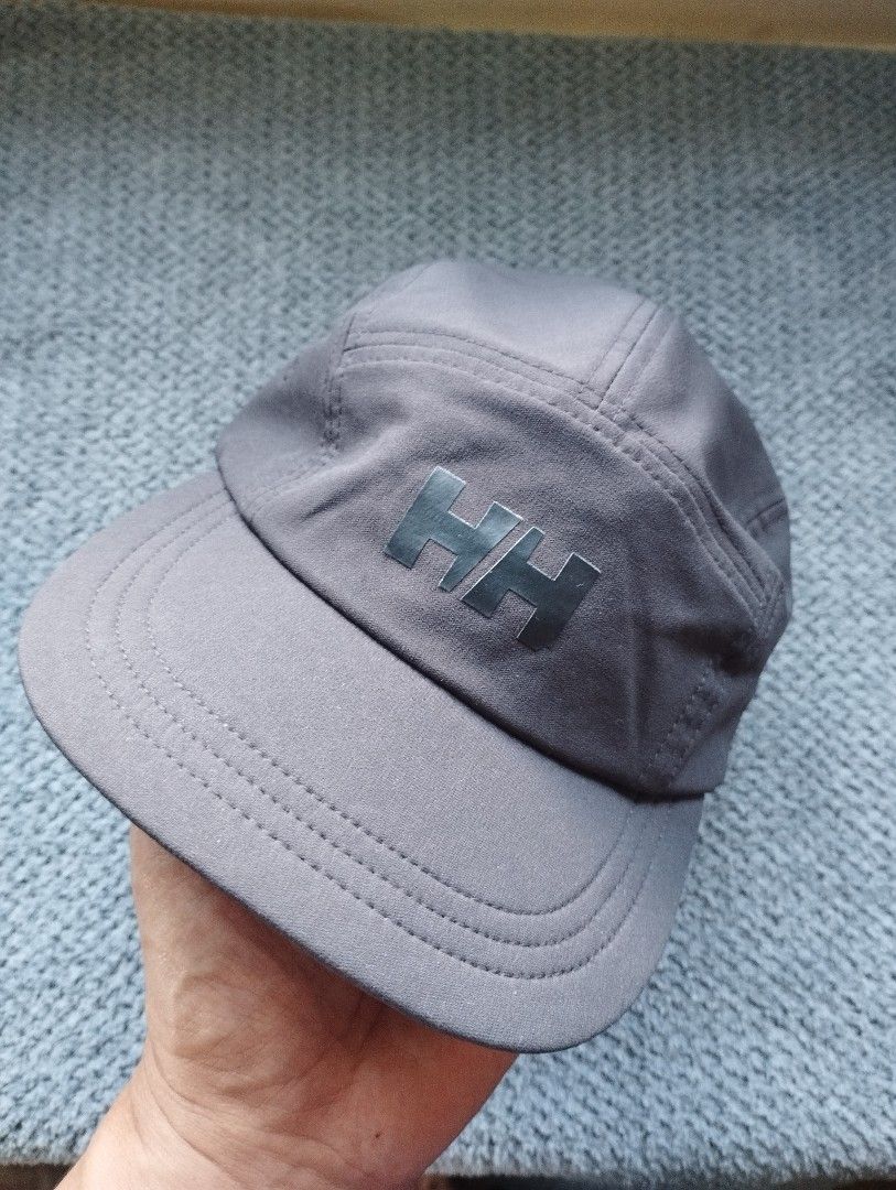 Helly Hansen Grey Athletic Cap (Category: Caps & Hats) located in Manila. Submitted by happycaps (Listing ID 1470408626, Image 1). Description: - Brand: Helly Hansen Packable Trail/Running Cap - Color: Dark Grey - Design: Classic 5-panel with rubberized HH front log - Fit: Adjustable elastic strap closure for a custom fit - Comfort: Textured inner lining for enhanced breathability - Ideal for: Outdoor activities, workouts, and casual wear .